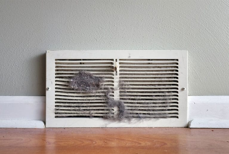Top Signs Your Raleigh Home Needs Professional Duct Cleaning 2 Dust and debris buildup around air vent in Raleigh NC home